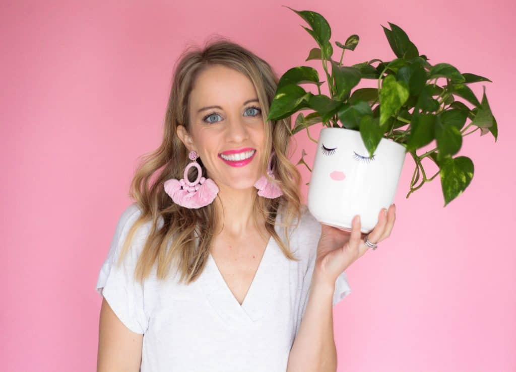 jen biswas of paisley plants holding a plant