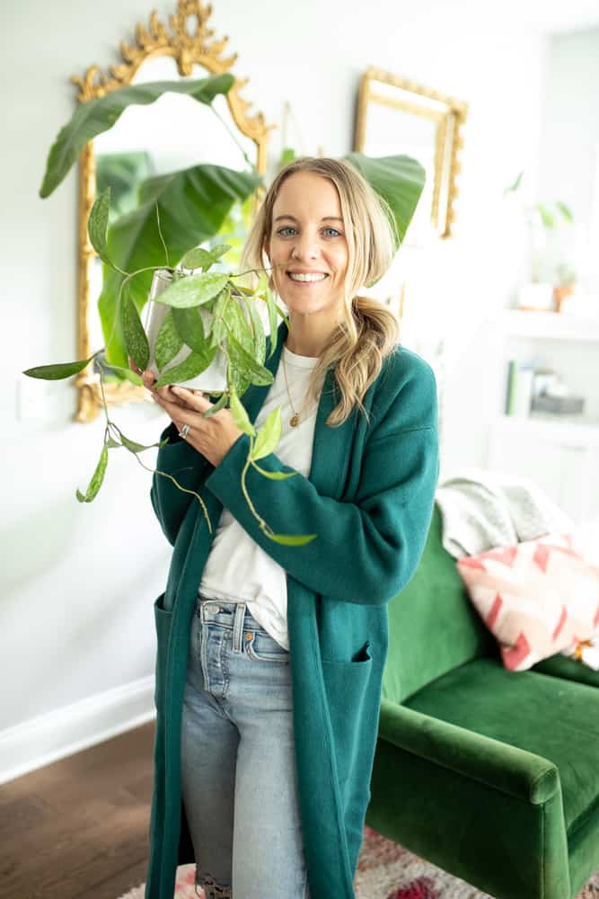 woman holding a Hoya Pubicalyx plant